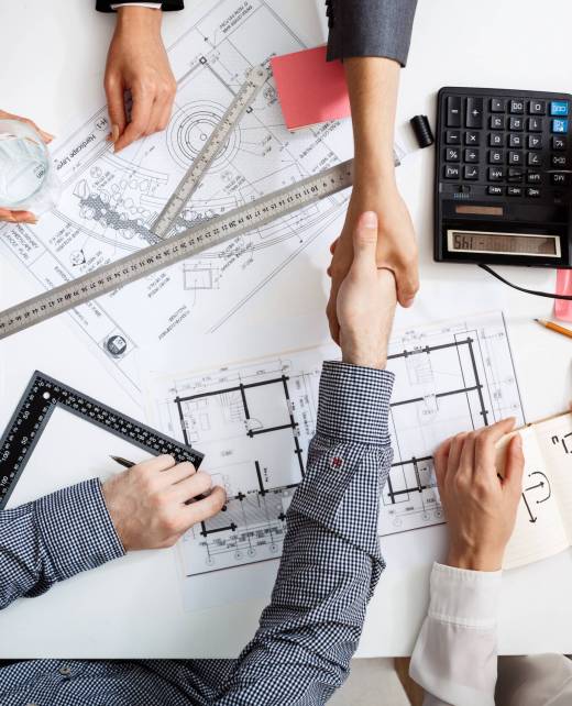 Picture of businessmen's hands on white table with documents, coffee and drafts